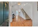 Inviting foyer featuring hardwood floors and a staircase leading to the second level at 3 Yancey, Pittsboro, NC 27312