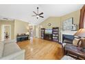 Open living room boasts vaulted ceilings, fireplace, and hardwood floors at 30 Cornerstone Dr, Franklinton, NC 27525