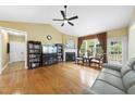 Inviting living room with a fireplace, ceiling fan, and large window, perfect for relaxation at 30 Cornerstone Dr, Franklinton, NC 27525