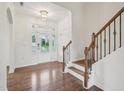 Bright foyer with hardwood floors, staircase, and a clear view through the glass front door at 316 Wellwater Ave, Durham, NC 27703