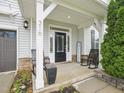 Inviting front porch with rocking chairs, a potted plant, and stone accents at 316 Wellwater Ave, Durham, NC 27703