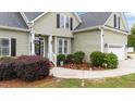 Beautiful entrance with an inviting doorway, front yard landscaping, and manicured shrubbery at 3216 Nc Hwy 42, Willow Springs, NC 27592