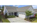 Lovely blue home with a two-car garage, complemented by lush landscaping and a well-kept lawn at 3309 Turner Ridge Dr, New Hill, NC 27562