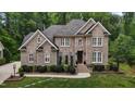 Stunning brick home with detailed trim, complemented by mature landscaping and a manicured lawn at 3323 Cheswick Dr, Raleigh, NC 27609