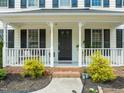Inviting front porch with white railings and decorative plants at 3401 Sitzman Ct, Raleigh, NC 27616