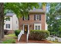 Charming two-story brick home with black shutters and manicured landscaping at 4 Weathergreen Ct, Durham, NC 27713