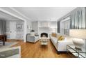 Bright living room with hardwood floors, a fireplace, and comfortable seating at 4 Weathergreen Ct, Durham, NC 27713
