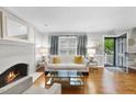 Bright living room featuring hardwood floors, a fireplace, and neutral decor at 4 Weathergreen Ct, Durham, NC 27713