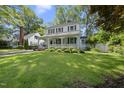 Charming home with inviting front porch, swing, and lush green lawn offering timeless appeal at 406 E Lee St, Smithfield, NC 27577