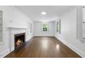 Bright, minimalist living room with hardwood floors, fireplace, and natural light creates a cozy ambiance at 406 E Lee St, Smithfield, NC 27577