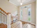 Bright entryway features hardwood floors and a staircase with wooden railing at 4125 Enfield Ridge Dr, Cary, NC 27519