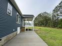 The exterior of the home features a screened-in back porch and a concrete patio at 4167 Old Stage N Rd # 4, Angier, NC 27501