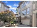 Charming exterior of a townhome with stone accents, attached garage, tree in the yard, and well-maintained landscaping at 4802 Glenmist Ct, Raleigh, NC 27612