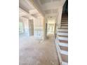 Unfinished living room boasts coffered ceilings, wainscoting, and a view of the staircase at 50 Moonraker Dr, Spring Hope, NC 27882