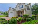 Lovely home featuring a well-manicured lawn, a quaint front porch, and a spacious two-car garage at 5535 Spindlewood Ct, Durham, NC 27703