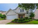 Charming home featuring well-manicured lawn, stone accents and a two-car garage at 5535 Spindlewood Ct, Durham, NC 27703