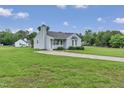 Cozy home featuring a well-manicured lawn and a convenient driveway, offering comfort and practicality at 5849 Rocking Chair Dr, Youngsville, NC 27596