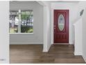 Inviting foyer with light walls, wood-look floors, and a decorative front door with glass insert at 5940 Brambleton Ave, Raleigh, NC 27610