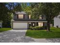 Traditional home showcasing a two-car garage, symmetrical windows, and landscaped front yard at 5940 Brambleton Ave, Raleigh, NC 27610