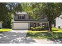Two-story home with a front-facing garage and manicured lawn at 5940 Brambleton Ave, Raleigh, NC 27610