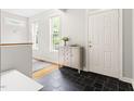 Entryway featuring black tile floor, neutral walls, and a cabinet with decor at 601 Culpepper Ct, Durham, NC 27712