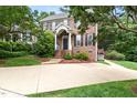 Beautiful two-story brick home with a well-manicured lawn, mature trees, and welcoming front entry at 601 Culpepper Ct, Durham, NC 27712