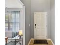 Inviting foyer with a white front door, tiled floor, and gray walls creates a welcoming entryway at 8008 Bright Oak Trl, Raleigh, NC 27616