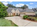 Stunning brick home with a basketball court in the driveway and an attached three-car garage at 8904 Milden Hall Ct, Raleigh, NC 27615