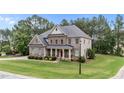 Charming two-story home with a covered front porch, landscaped yard, and attached garage at 10 Stillwood Ct, Clayton, NC 27520