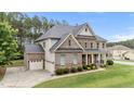 Lovely two-story brick home featuring an attached two car garage and manicured lawn at 10 Stillwood Ct, Clayton, NC 27520