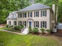 Beautiful two-story home with a blue front door and lush green lawn and professional landscaping at 10317 Roadstead W Way, Raleigh, NC 27613