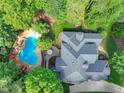 An aerial view of a gorgeous home with a private pool and lush landscaping at 10540 Byrum Woods Dr, Raleigh, NC 27613