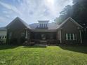 Large backyard with mature trees and a spacious porch, perfect for outdoor entertaining and relaxation at 11221 Paddy Hollow Ln, Raleigh, NC 27614