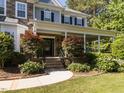 Inviting front porch with stone columns, manicured landscaping, and a curved walkway leading to the entrance at 1201 Kalworth Rd, Wake Forest, NC 27587