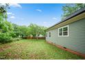 Expansive backyard with lush greenery and mature trees, providing privacy and natural beauty at 129 E Chestnut Ave, Wake Forest, NC 27587