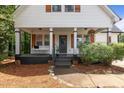 Charming front exterior featuring a cozy porch and manicured landscaping for added appeal at 14 Donnibrook, Fuquay Varina, NC 27526