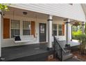 Cozy front porch with a swing, offering a relaxing outdoor space to enjoy at 14 Donnibrook, Fuquay Varina, NC 27526
