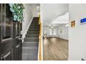 Inviting entryway with hardwood floors, staircase, and an open view into the spacious living area at 149 Hutson Ln, Clayton, NC 27527