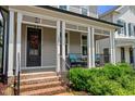 Inviting front porch featuring brick stairs, columns, and seating area at 190 Wendover Pkwy, Pittsboro, NC 27312