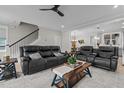 Spacious living room featuring a comfortable leather sofa and open floor plan at 190 Wendover Pkwy, Pittsboro, NC 27312