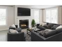 Cozy living room with a fireplace, comfortable seating, and large windows for natural light at 2000 Kapalua Way # 187, Durham, NC 27703