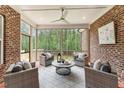 Cozy screened porch with comfortable seating, offering a peaceful outdoor living space with views of the surrounding woods at 2028 Pleasant Forest Way, Wake Forest, NC 27587