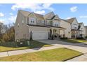 Attractive two-story home boasting a covered front porch and a convenient two-car garage at 204 Woodstaff Ave, Wake Forest, NC 27587