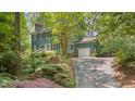 Charming two-story home features a brick walkway, mature landscaping, and a convenient attached garage at 207 Old Forest Creek Dr, Chapel Hill, NC 27514