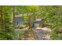 Charming two-story home features a brick walkway, mature landscaping, and a convenient attached garage at 207 Old Forest Creek Dr, Chapel Hill, NC 27514