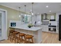 Modern kitchen featuring stainless steel appliances, a center island with stools, and ample counter space at 207 Old Forest Creek Dr, Chapel Hill, NC 27514