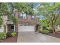 Charming brick townhome with a two-car garage, manicured landscaping, and a welcoming entrance at 2073 Weston Green Loop, Cary, NC 27513