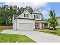 Charming white home featuring an attached garage, a welcoming front porch, and a spacious driveway at 22 Chapman Ct, Wendell, NC 27591