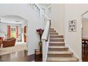 Bright foyer with staircase, hardwood floors, and views into adjacent living spaces at 2207 Wimberly Woods Dr, Sanford, NC 27330