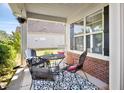 Cozy covered patio with a table, chairs, and stylish outdoor rug at 2207 Wimberly Woods Dr, Sanford, NC 27330